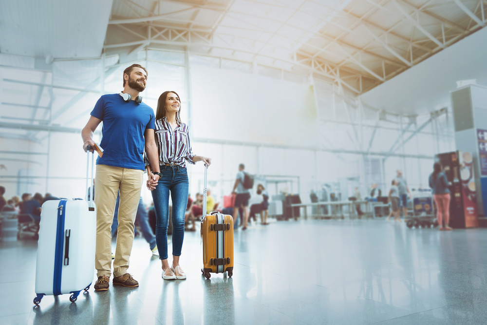 Breezing through Security and Layovers: Merry smiling couple waiting for plane 