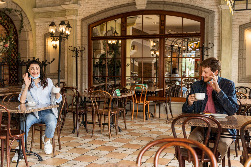 The Role of Coffee in Lisbon's Social and Cultural Fabric: Friends drinking coffee, waving at each other while respecting the social distance 