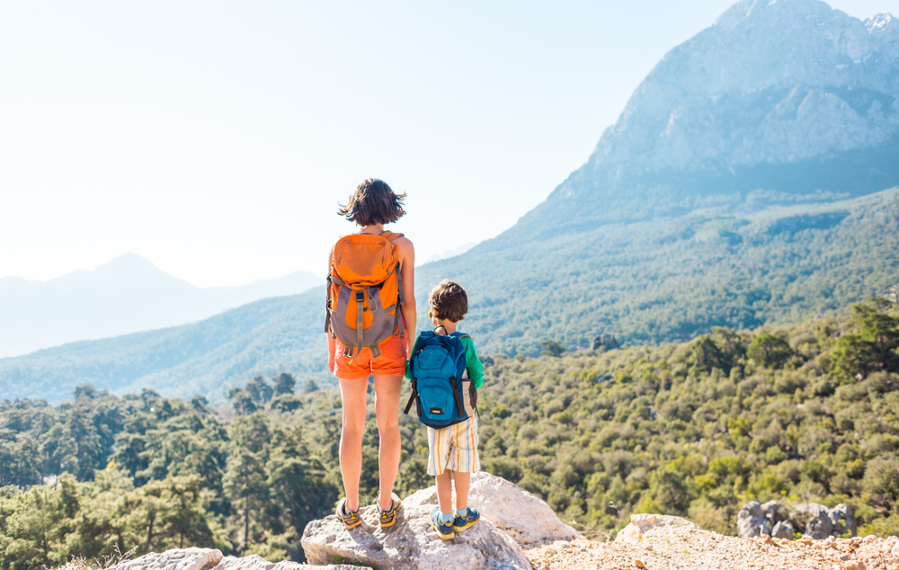 Mysteries and Myths: Uncovering the Legends of Meteora: . A woman is traveling with a child. Boy with his mother looking at the mountains. Travel with backpacks. Hike and climb with kids. 