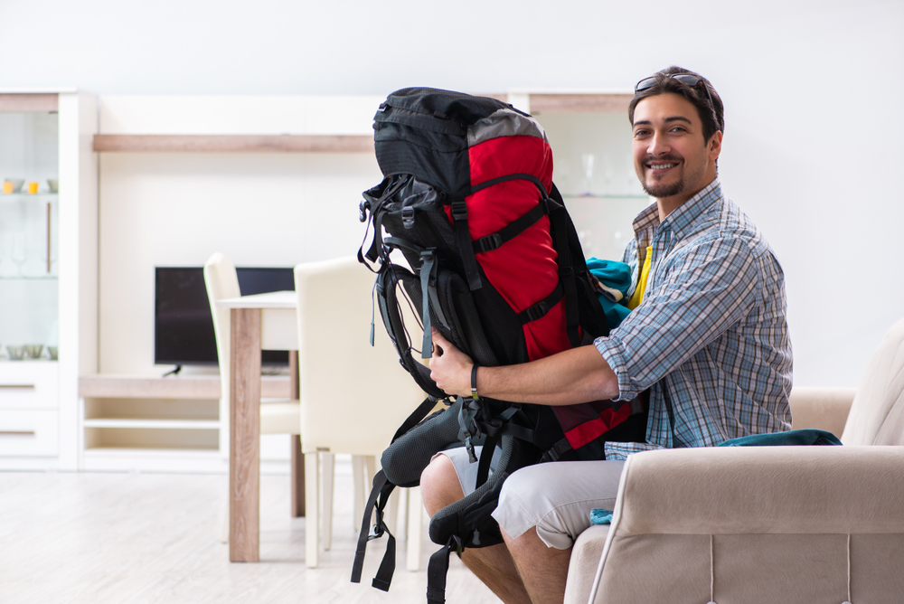 Getting Started with Couchsurfing: Backpacker packing for his trip 