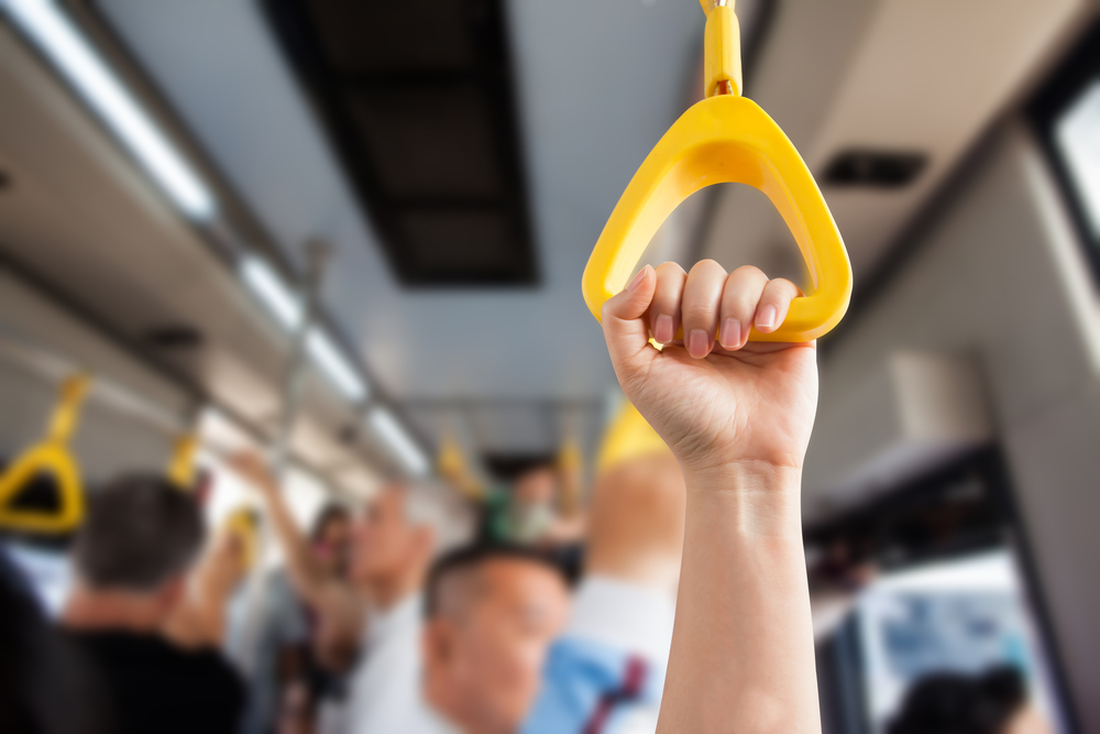 A Visitor's Guide to Getting Around Lisbon’s Trams: People Hand holding Handle on the train .Clipping path 