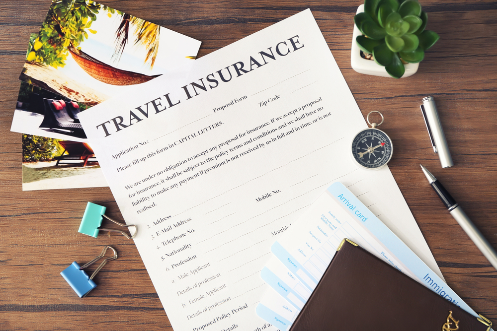 What Not to Do When Choosing Travel Insurance: Blank Travel Insurance Form On Wooden Background Closeup