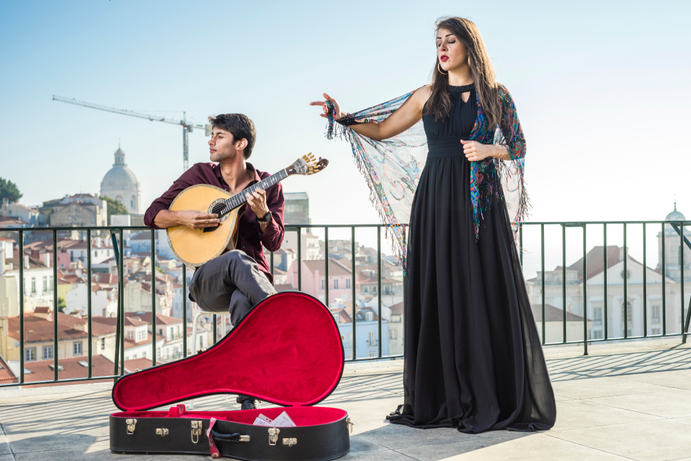 Budget-Friendly Experiences in LiPortugal's Capital: Beautiful fado singer performing with handsome portuguese guitarist player in Alfama, Lisbon, Portugal 