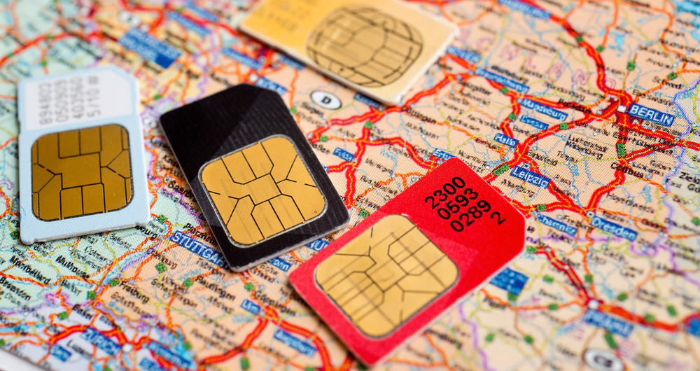 How to Stay Connected Abroad Without Breaking the Bank: many sim cards with the map on background 