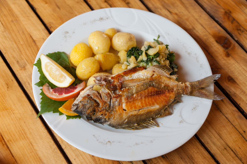 Exploring the Hidden Gems of Zadar's Old Town: A traditional plate of grilled fish and sides in Croatian restaurant 