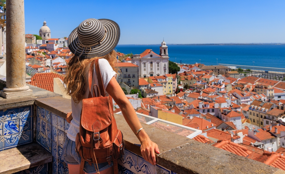 Budget-Friendly Experiences in LiPortugal's Capital: Woman tourist enjoying panoramic view of Lisbon city landscape- Portugal 