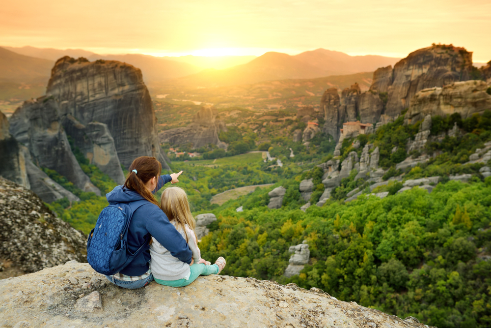 Walking Tours of Meteora: Mother and daughter exploring Meteora valley, a rock formation in central Greece hosting one of the largest complexes of Eastern Orthodox monasteries. 