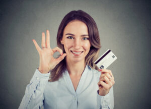 Happy Young Business Woman With Credit Card Giving Ok Hand